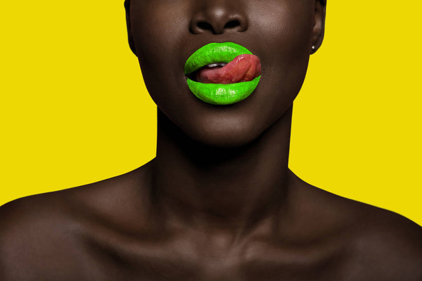 concept of afro black woman with green lipstick and yellow backg - Фото, изображение
