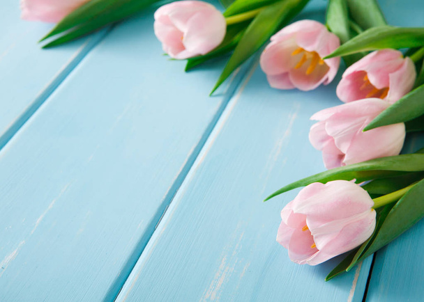 Pink tulips on blue wood background, copy space - Photo, Image