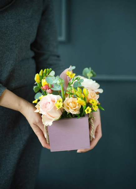 nice bouquet in the hands of woman, close up - Photo, Image