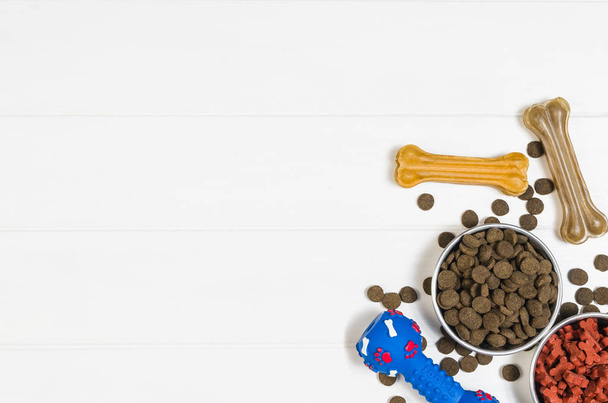 Dry dog food and accessories on white background top view - Foto, afbeelding