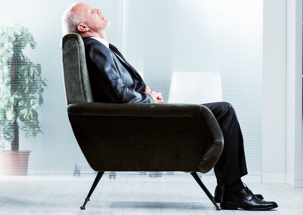 Tired businessman taking a moment to relax - Photo, Image