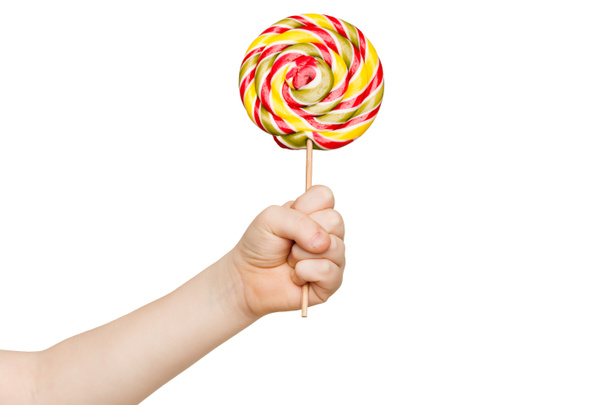 Childs hand holding big colorful lollipop - Photo, Image