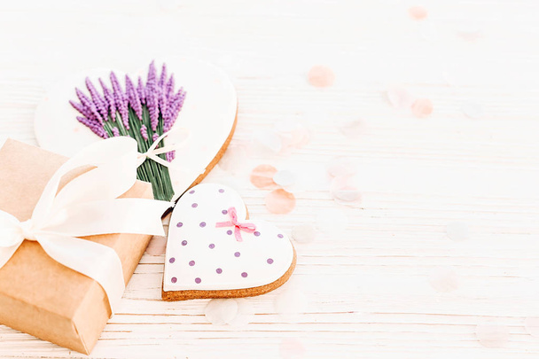 cookie heart with lavender flowers and craft gift box on white rustic wood background  flat lay. space for text. happy valentine's day or women's. happy mother's day greeting card. - Photo, Image
