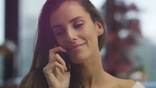 4K Attractive of smiling woman talking on cell phone at home - Imágenes, Vídeo