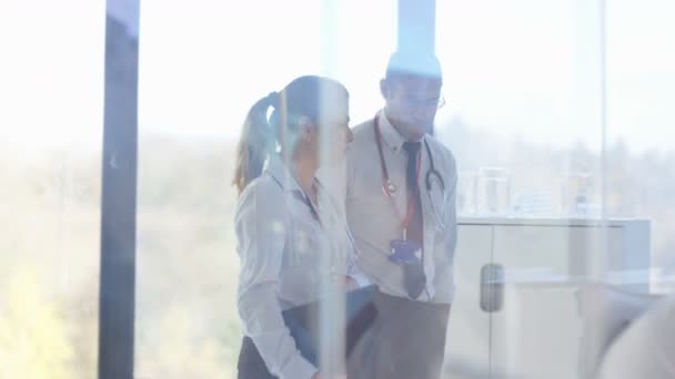 4K Hospital doctors in a meeting discussing patient x-ray and medical notes - Filmagem, Vídeo
