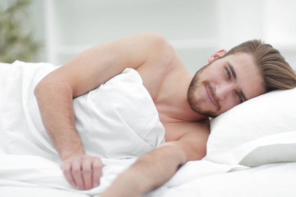 happy man, falling asleep in a comfortable bed - Photo, Image