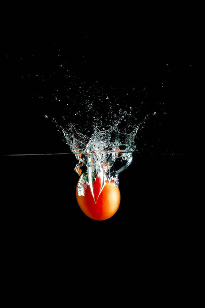 tomato in water splash - Foto, afbeelding
