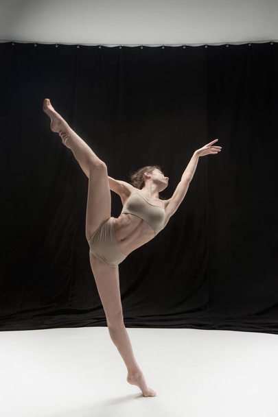 Young teen dancer on white floor background. - Фото, зображення