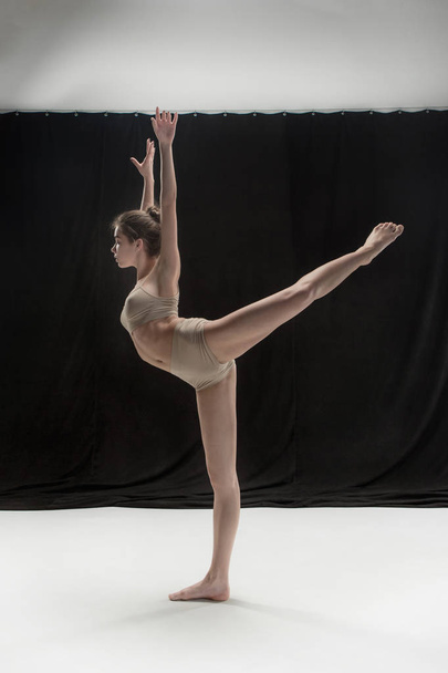 Young teen dancer on white floor background. - Foto, imagen