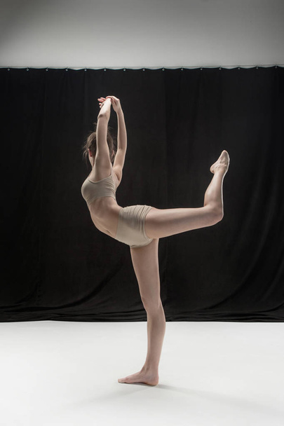 Young teen dancer on white floor background. - Фото, изображение