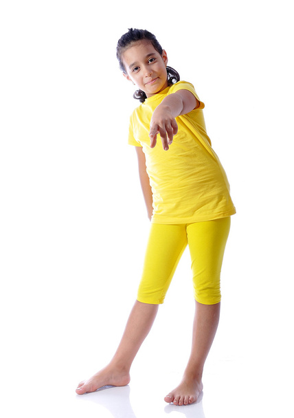Beautiful cute girl in yellow clothes is - Zdjęcie, obraz
