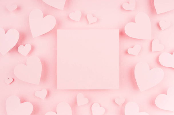 Blank pink square page with paper hearts on light background. Advertesign concept for Valentine day. - Zdjęcie, obraz