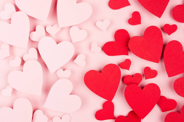 Valentine day background. Stream of fly paper red and pink hearts on pink color backdrop. - Foto, Bild