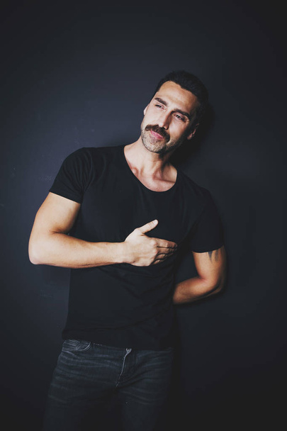 Young handsome man with beard and mustache studio portrait - 写真・画像