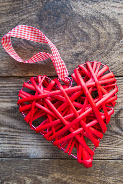 red wicker heart on a wooden background - Фото, зображення