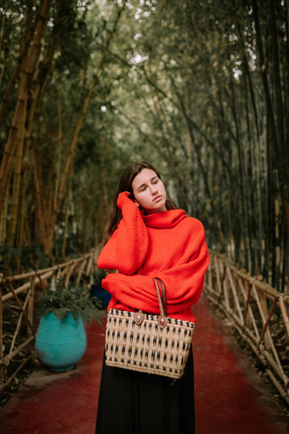 Young woman on a path of bamboo trees - Photo, image