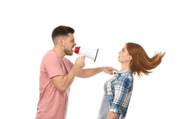Angry man with megaphone scolding his wife on white background - Zdjęcie, obraz