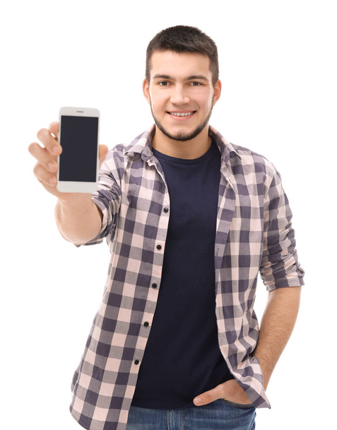Young man with cell phone on white background - Fotoğraf, Görsel
