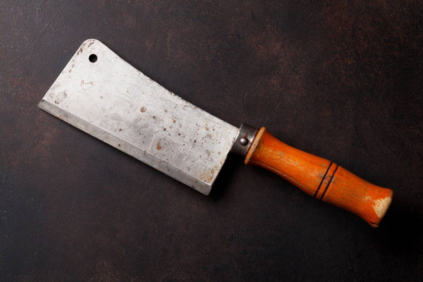 Butcher. Vintage meat knife over stone table. Top view - Photo, Image