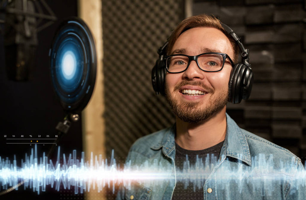 man with headphones singing at recording studio - 写真・画像