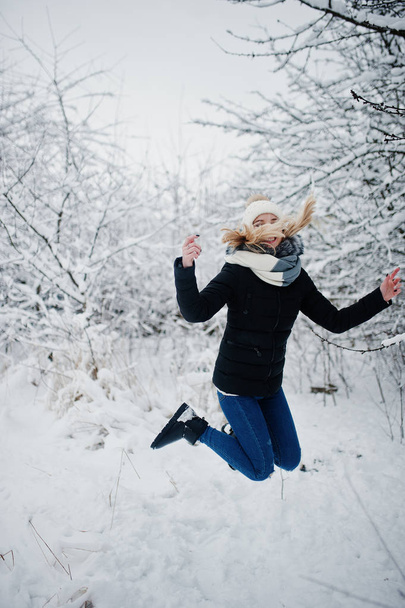 Blonde girl having fun with snow at winter day. - Фото, изображение