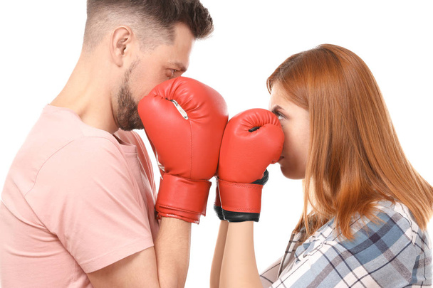 Angry couple in boxing gloves on white background - Фото, изображение