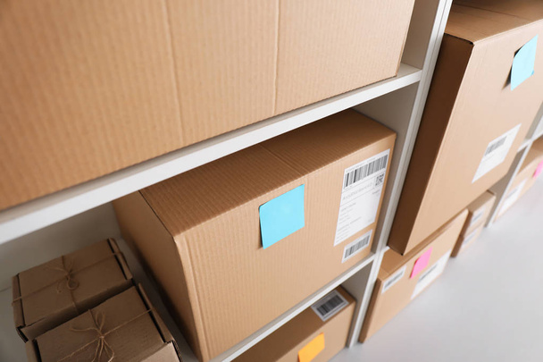 Shelving with parcels ready for shipment to customers in home office. Startup business - 写真・画像