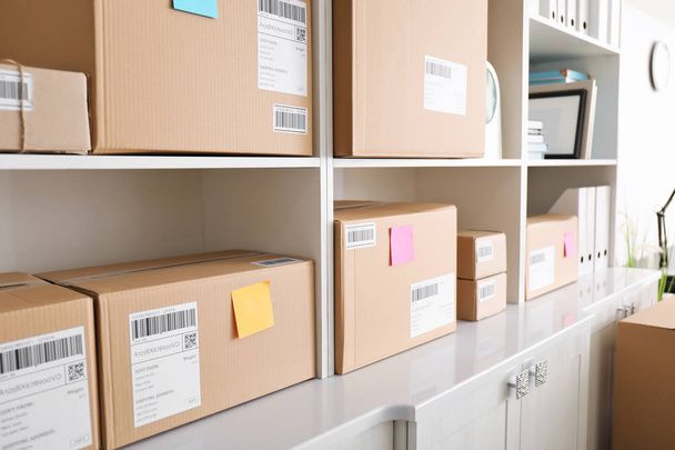 Shelving with parcels ready for shipment to customers in home office. Startup business - Photo, Image