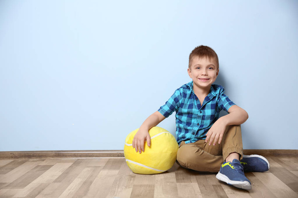Cute little boy with soft toy near color wall - Φωτογραφία, εικόνα