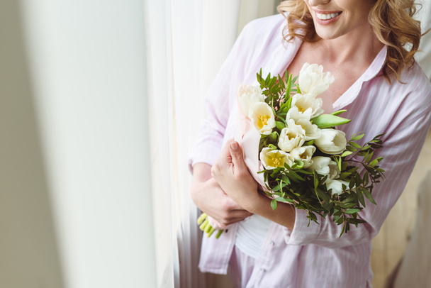 cropped view of woman with bouquet of spring flowers - Photo, image