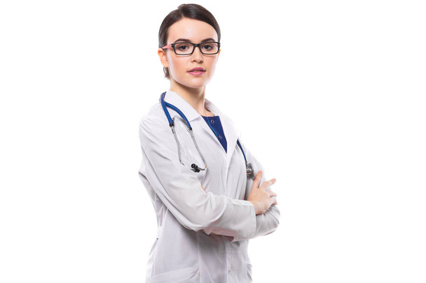 Young female doctor with stethoscope standing with arms crossed and looking at camera - Фото, изображение