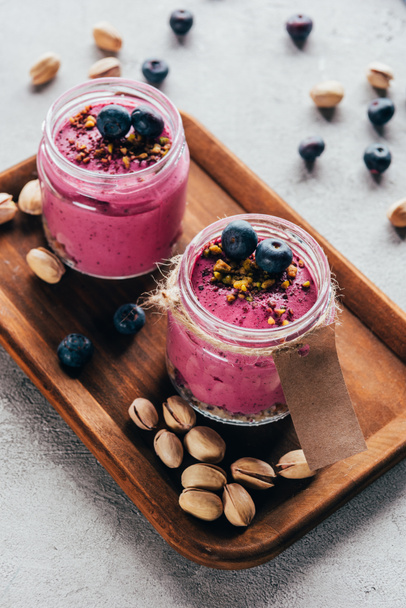 delicious healthy pink smoothie with nuts and berries - Photo, Image