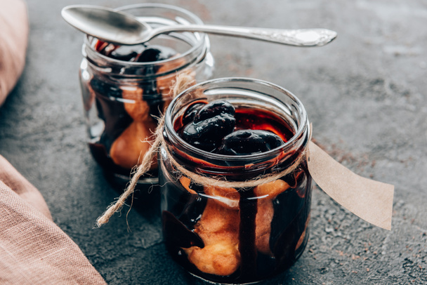 close-up view of sweet delicious homemade chocolate dessert in glass jars - Фото, изображение