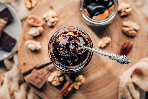 top view of sweet c chocolate dessert in glass jar with spoon   - Fotografie, Obrázek