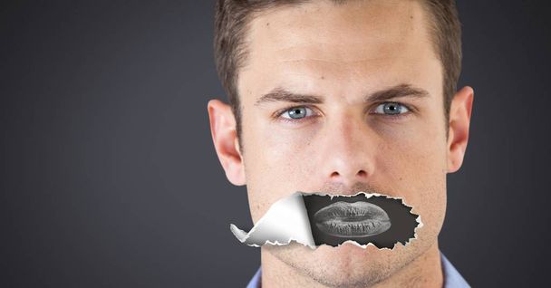 Digital composite of Man with torn paper on mouth and lips negative - Photo, Image