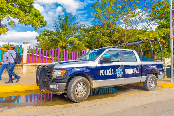 Playa del Carmen, Mexico - January 10, 2018: View of a blue police van parked at outdoors in 5th Avenue, the main street of the city. The city boasts a wide array of tourist activities due to its - 写真・画像
