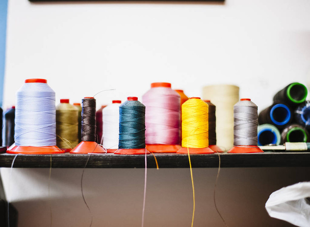 rolls of colored cotton thread for sewing with machine in store - Photo, Image