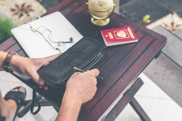 Man doing online shopping with credit card, laptop and luxury snakeskin python wallet. Man online shopping concept. - 写真・画像