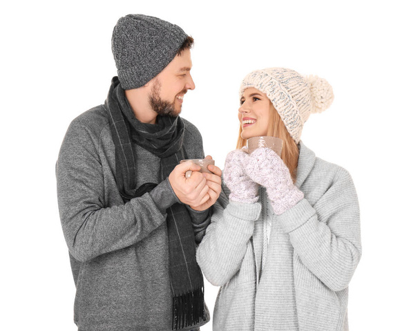 Young couple in warm clothing on white background. Ready for winter vacation - Foto, Imagem