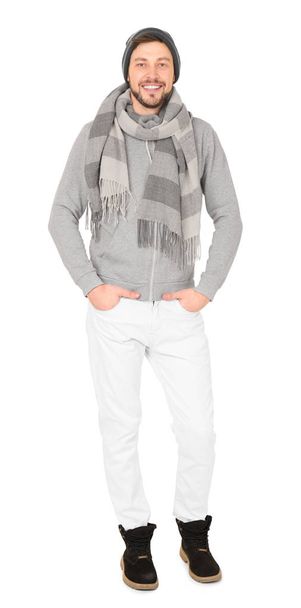 Young man in warm clothing on white background. Ready for winter vacation - Foto, Imagem