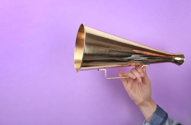 Woman holding megaphone on color background - Photo, Image