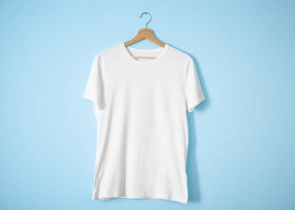 White t-shirt on color background. Mockup for design - Фото, изображение