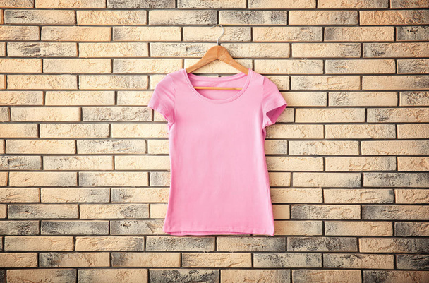 Color t-shirt on brick wall background. Mockup for design - Foto, Imagem