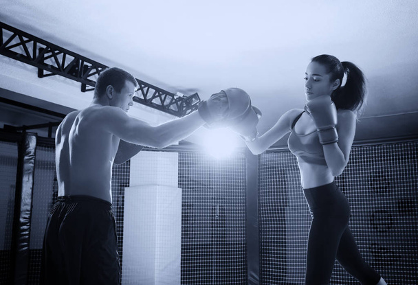Woman training with coach during boxing classes in gym - Foto, Bild