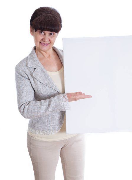 Mature woman leaning on white banner. Portrait against of white background - Foto, imagen