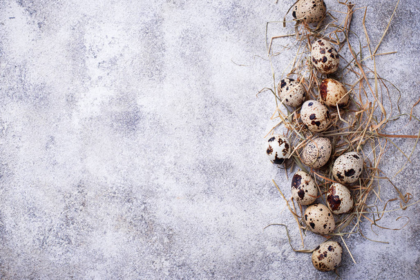 Quail eggs and straw on light background - Photo, Image