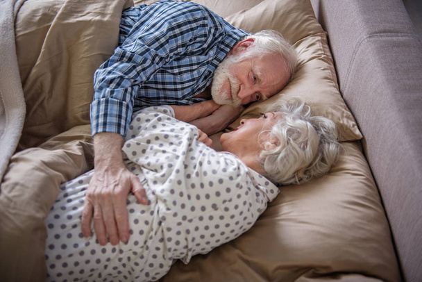 Glad senior couple relaxing at home - Фото, изображение