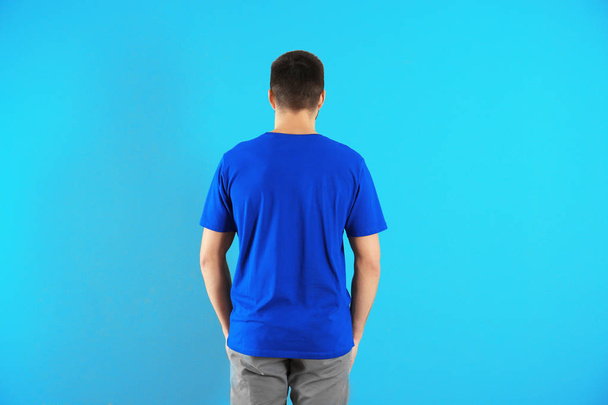 Young man in stylish t-shirt on color background. Mockup for design - 写真・画像