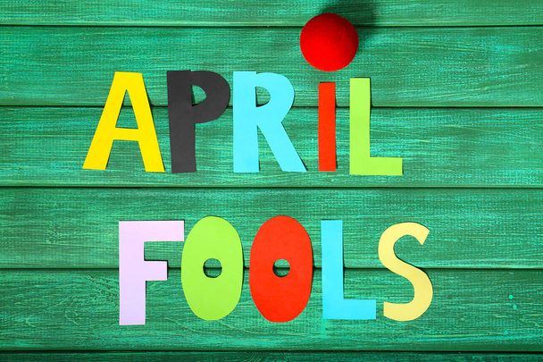 Composition with clown nose and phrase April fools on color background - Zdjęcie, obraz