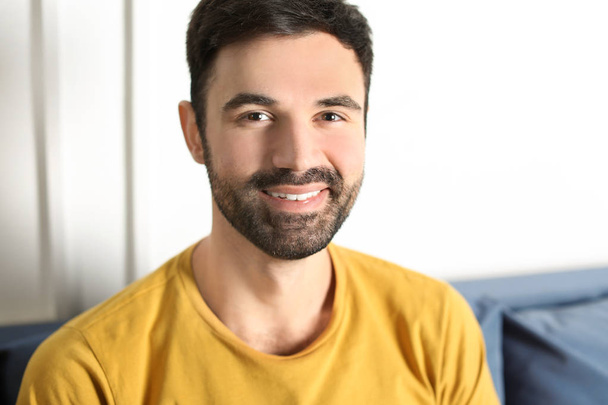 Young bearded man in casual clothes indoors - Foto, Imagen